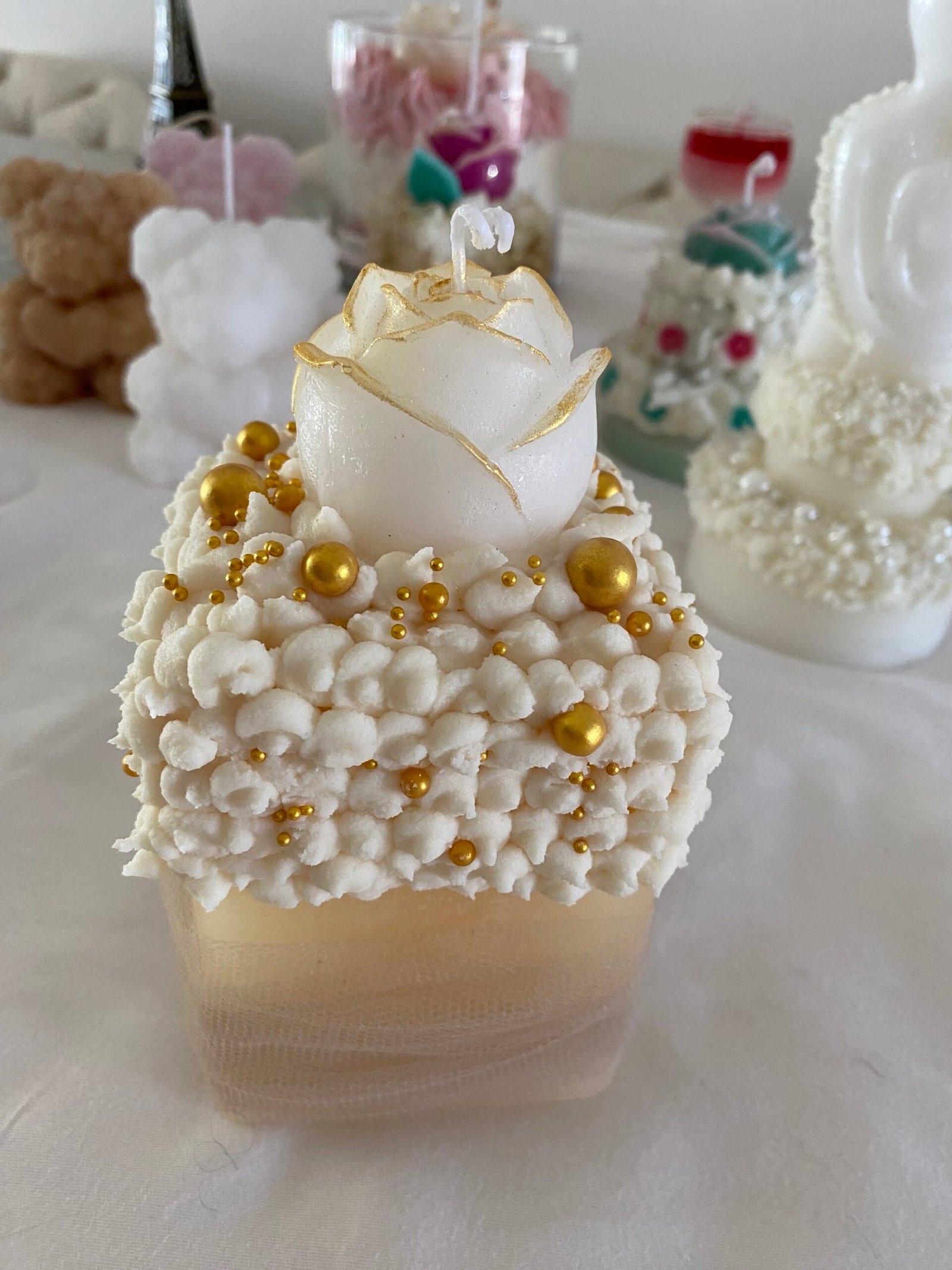 Candle with white rose and golden pearls