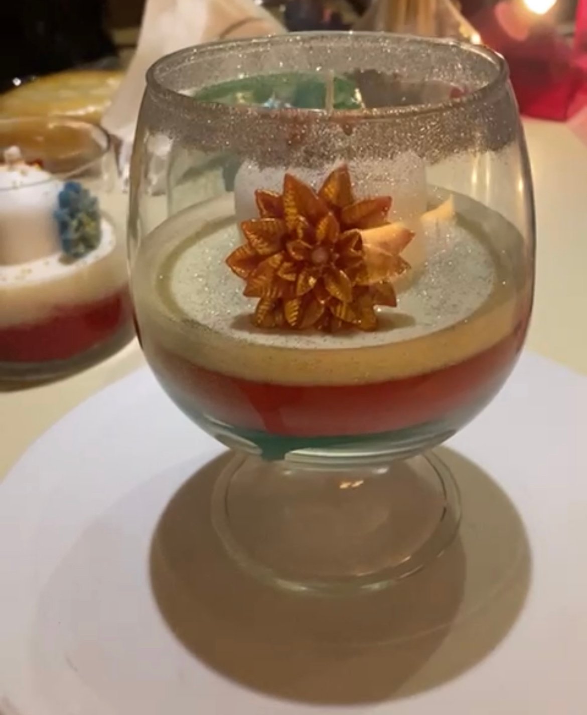 Christmas candle in a glass with flowers